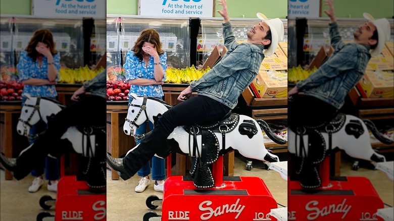 Brad Paisley riding coin-operated horse