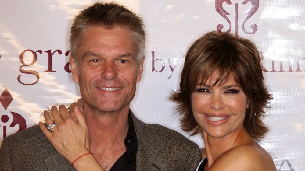 Harry Hamlin and Lisa Rinna, smiling with their arms around each other in 2010