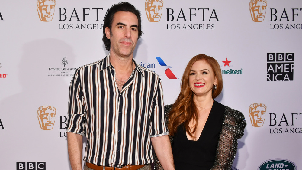 Sacha Baron Cohen and Isla Fisher smiling at the BAFTAs 