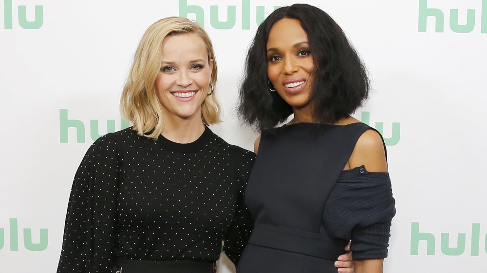 Reese Witherspoon and Kerry Washington arm in arm on red carpet 