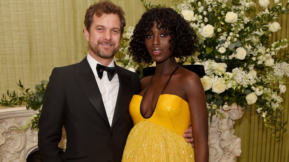 Joshua Jackson in a suit and Jodie Turner-Smith in a yellow dress