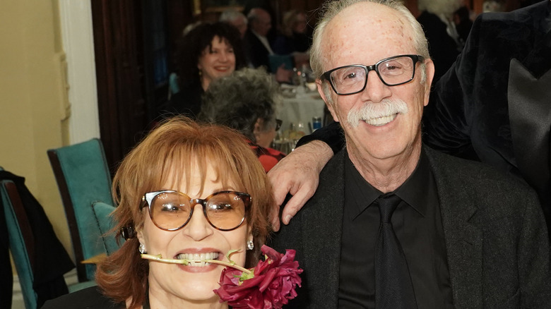 Joy Behar biting flower next to Steve Janowitz