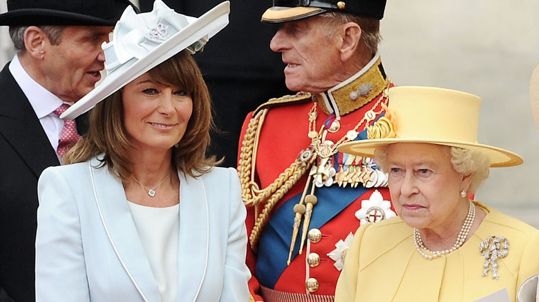 Carole Middleton smiling, Queen Elizabeth II yellow hat