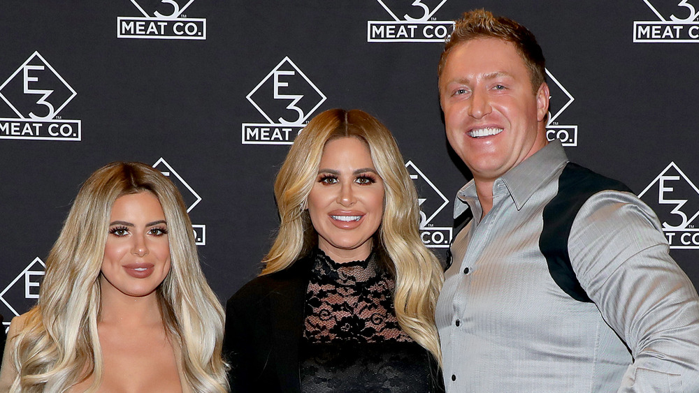 Brielle Biermann, Kim Zolciak-Biermann, and Kroy Biermann on the red carpet