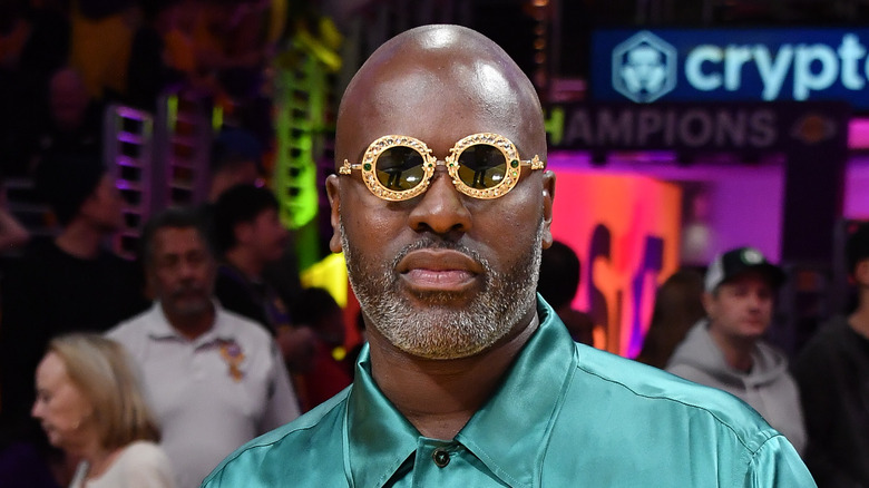 Corey Gamble posing in circular gold glasses