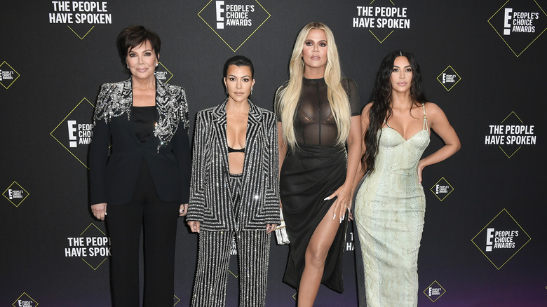 Kris Jenner, Kourtney Kardashian, Khloe Kardashian, and Kim Kardashian posing together on red carpet