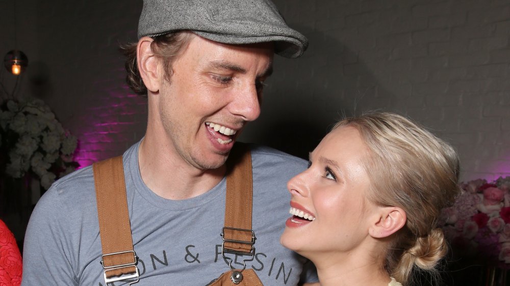 Dax Shepard and Kristen Bell laughing and smiling at one another