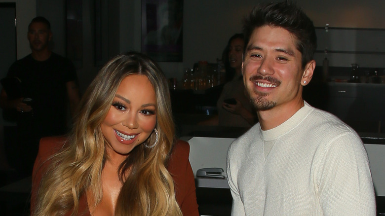 Mariah Carey and Bryan Tanaka smiling at an event