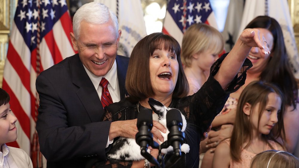 Karen Pence holding her pet bunny at a podium, Mike Pence laughing