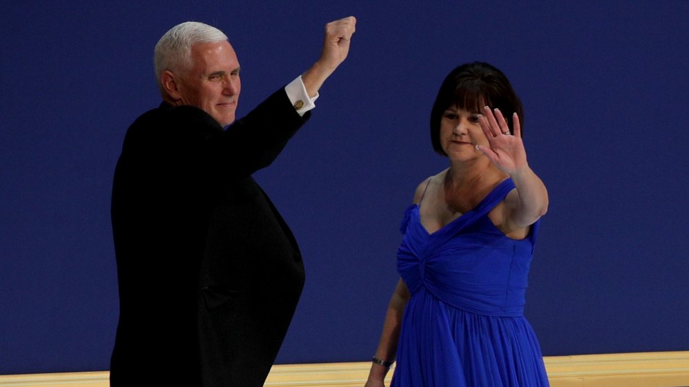 Mike Pence with fist in air, Karen Pence waving