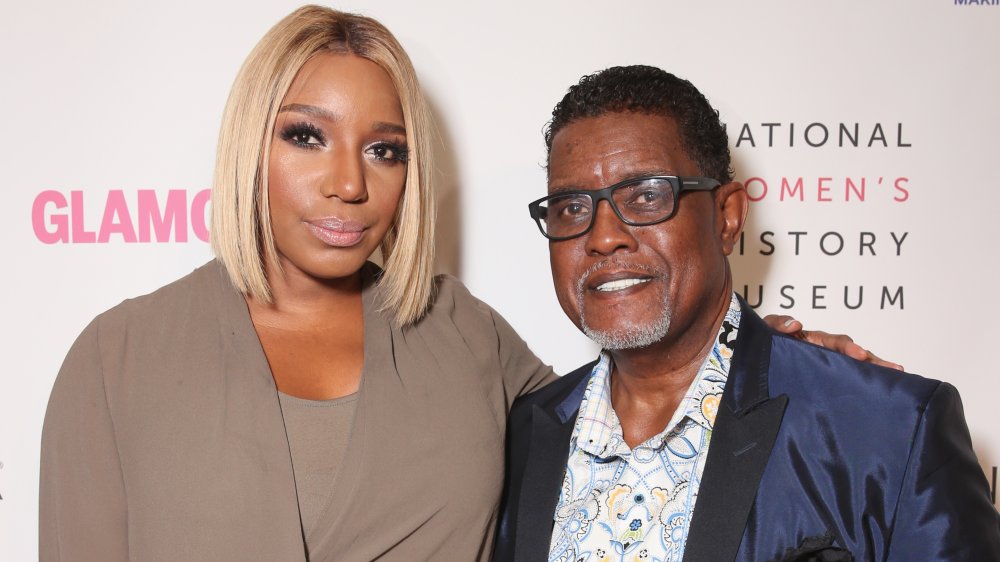 NeNe Leakes in a beige top, Gregg Leakes in a shiny blue jacket and patterned shirt