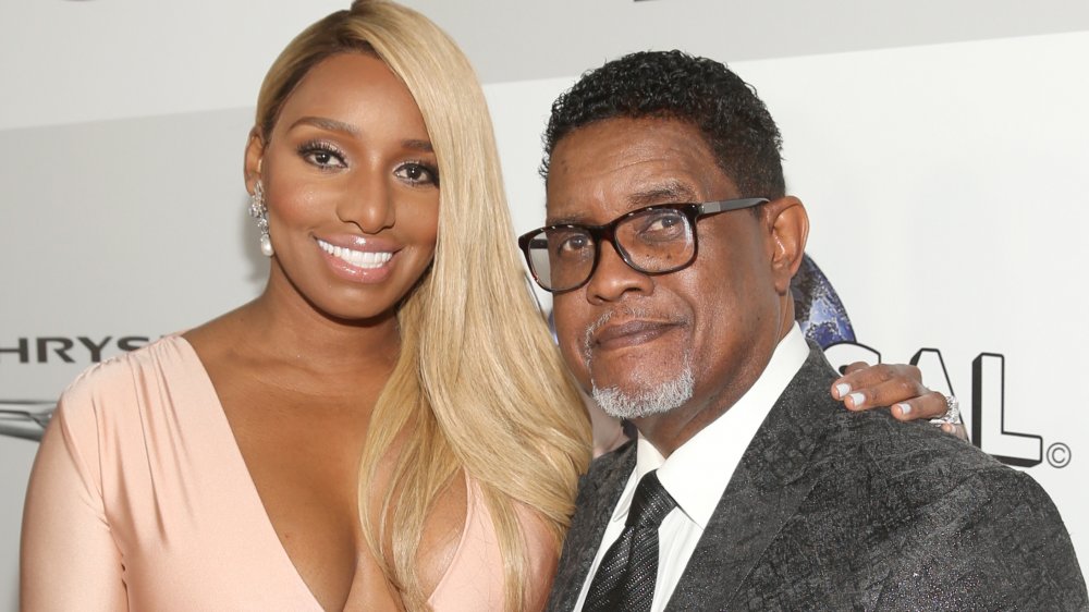 NeNe Leakes in a light-pink dress, Gregg Leakes in a charcoal suit