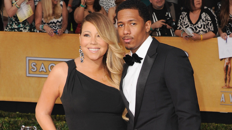 Nick Cannon posing with Mariah Carey