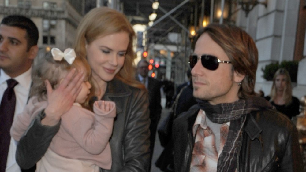 Nicole Kidman, Keith Urban walking with their daughter outside