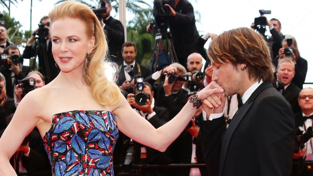 Keith Urban kissing Nicole Kidman's hand at a red carpet event