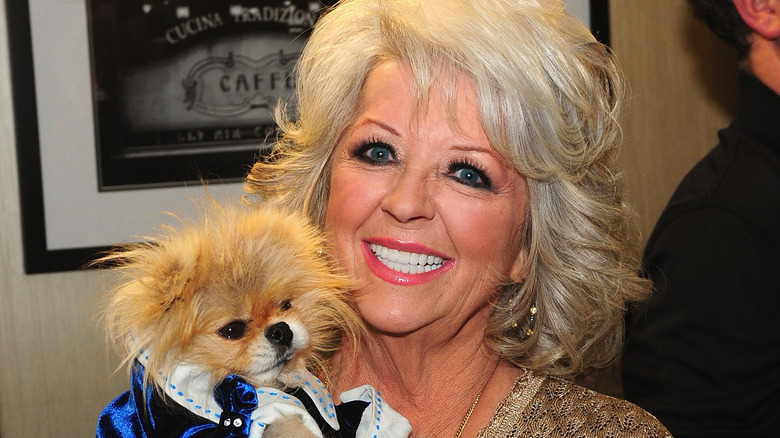 Paula Deen holds a dog