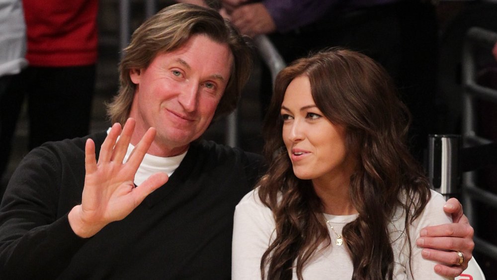 Wayne Gretzky with his arm around daughter Paulina Gretzky at a basketball game