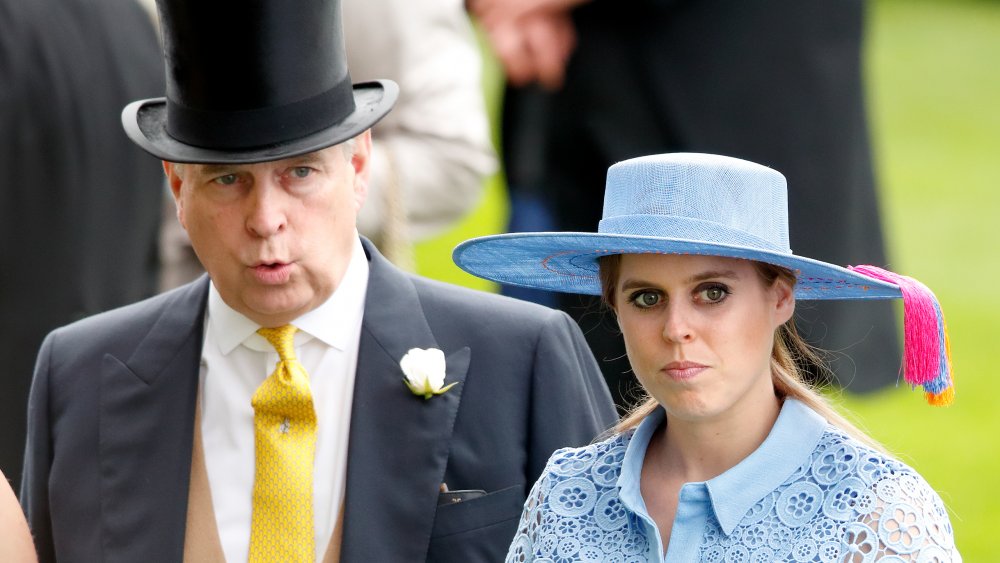 Prince Andrew and Princess Beatrice walking together, both with serious expressions