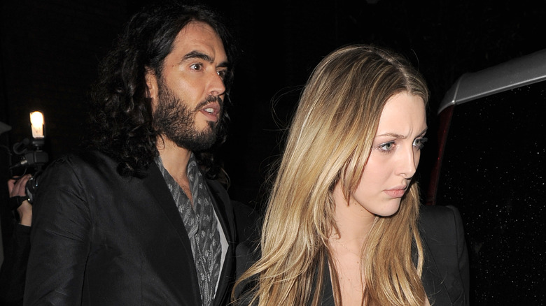 Russell Brand and wife Laura Gallacher look serious