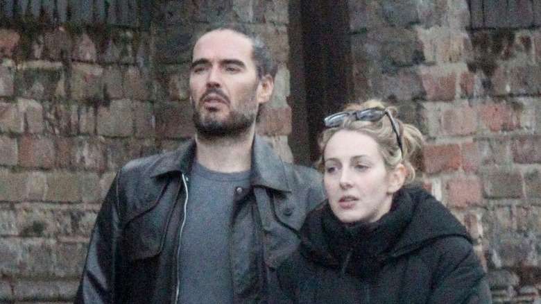 Russell Brand and Laura Gallacher look serious