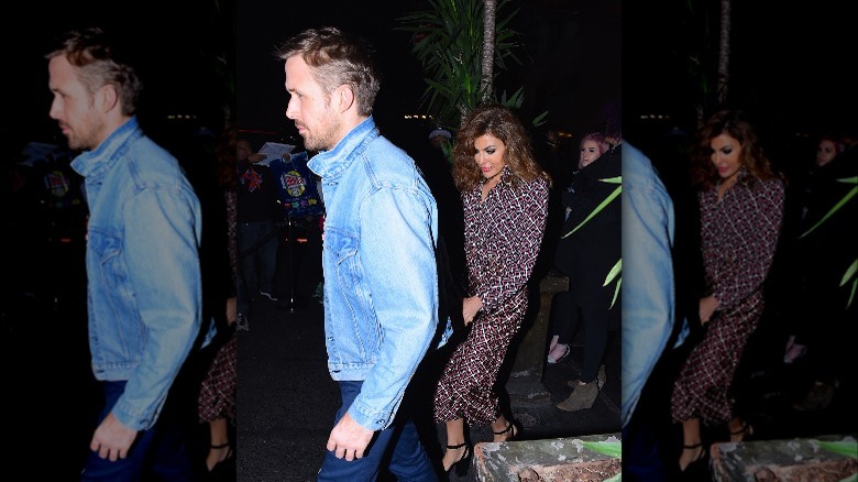 Ryan Gosling walks in front of Eva Mendes