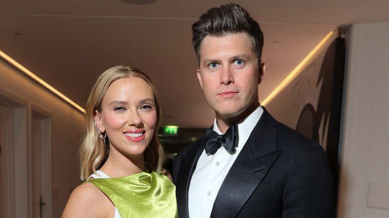 Colin Jost and Scarlett Johansson posing