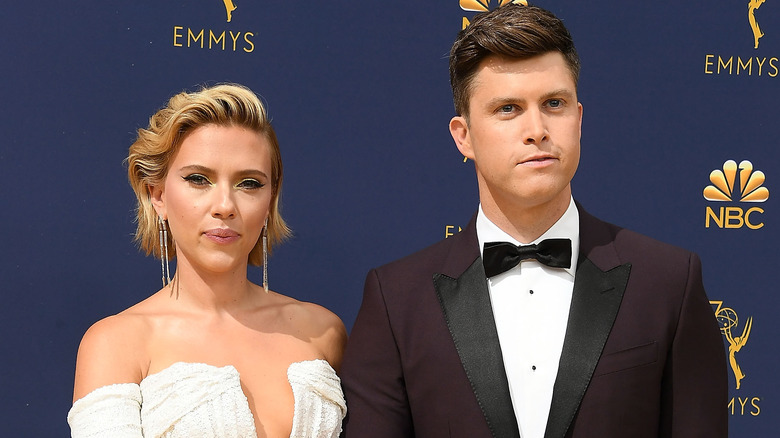 Colin Jost and Scarlett Johansson looking serious