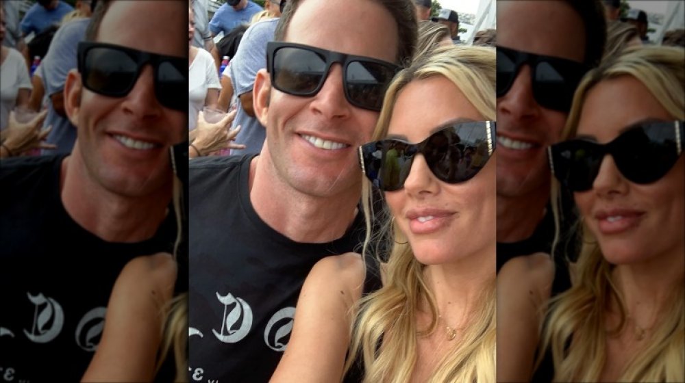 A selfie of Tarek El Moussa and Heather Rae Young wearing sunglasses and smiling