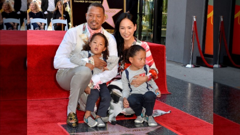 Terrence Howard and Mira Pak pose with their kids