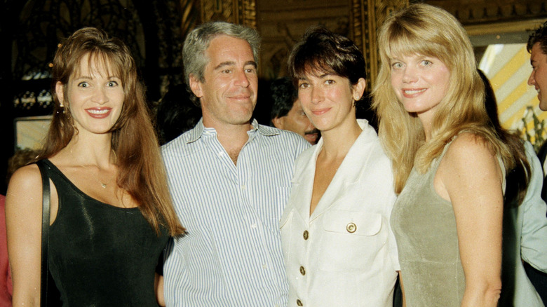 Jeffrey Epstein poses with friends at a party