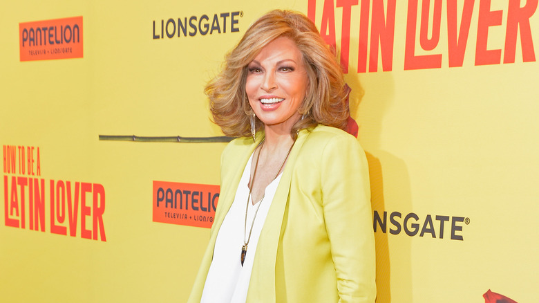 Raquel Welch smiles in a yellow blazer