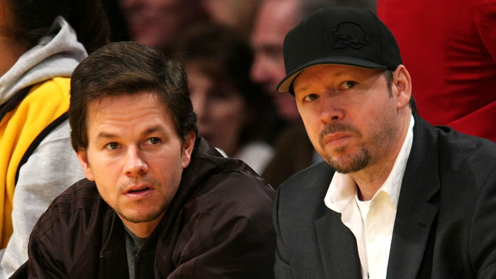 Mark Wahlberg and Donnie Wahlberg attending NBA game