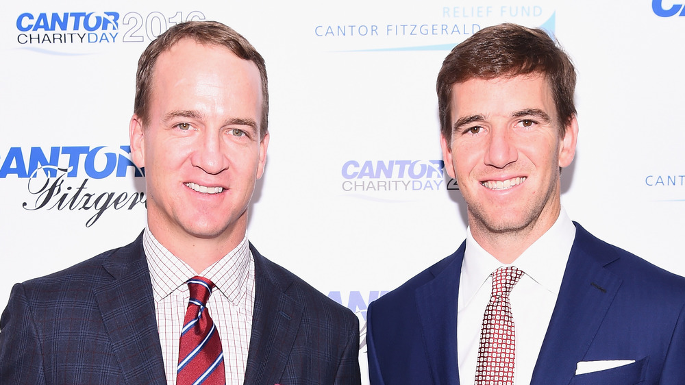 Peyton Manning and Eli Manning smiling