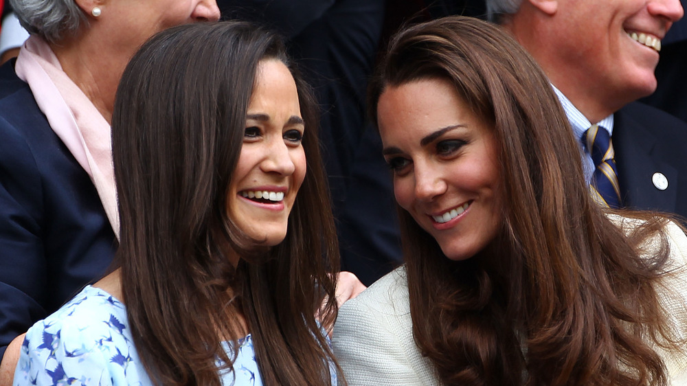 Pippa Middleton and Kate Middleton smiling together