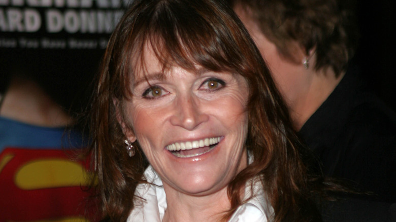 Margot Kidder smiling in white shirt