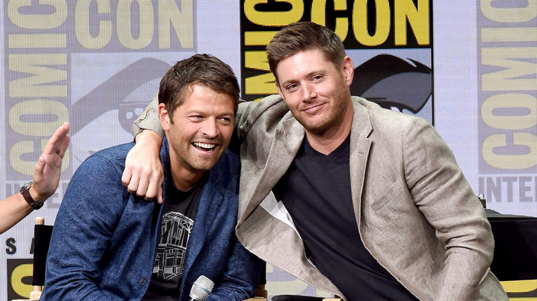 Jensen Ackles with arm around Misha Collins