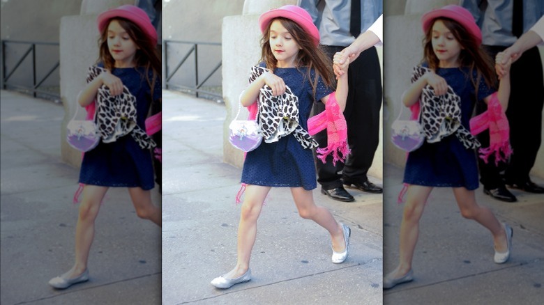 Suri Cruise wearing pink hat, silver ballet flats