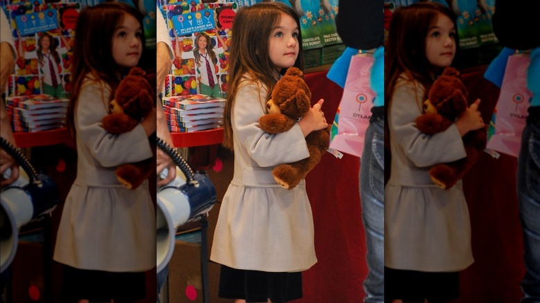 Suri Cruise holding teddy bear