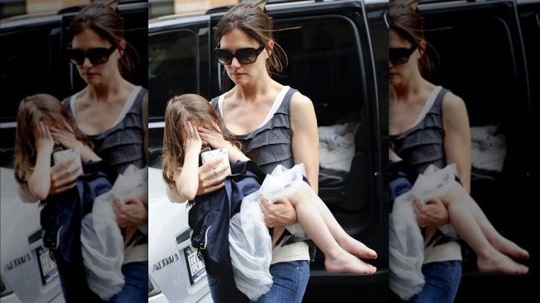 Katie Holmes carrying Suri Cruise