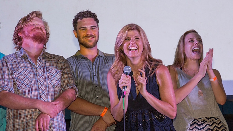 Friday Night Lights cast members laughing on a stage