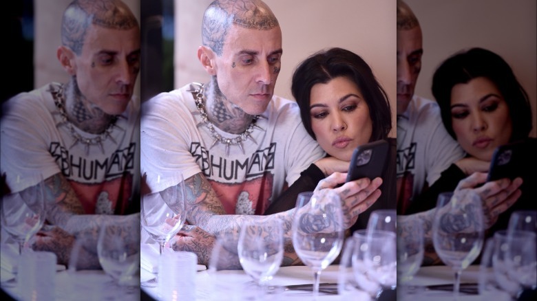 Kourtney Kardashian and Travis Barker taking a selfie