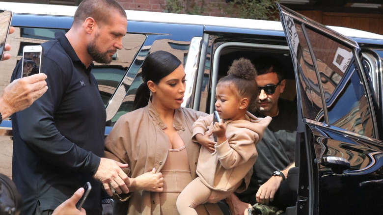 Kim Kardashian and child flanked by security