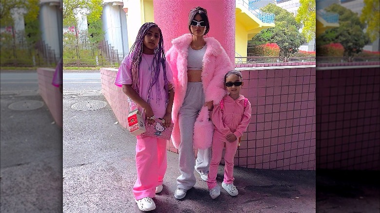 Kim Kardashian posing in pink with kids