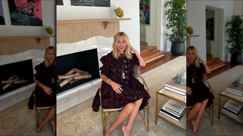 Sutton Stracke sitting by her fireplace