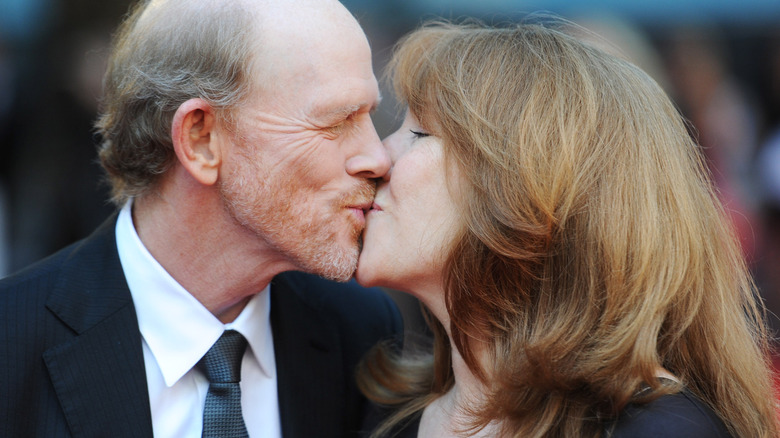 Ron Howard and Cheryl Howard kissing on the red carpet