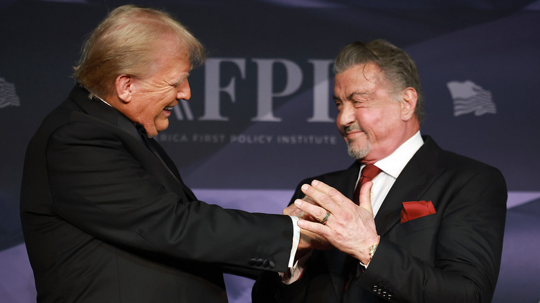 Donald Trump shaking hands with Sylvester Stallone