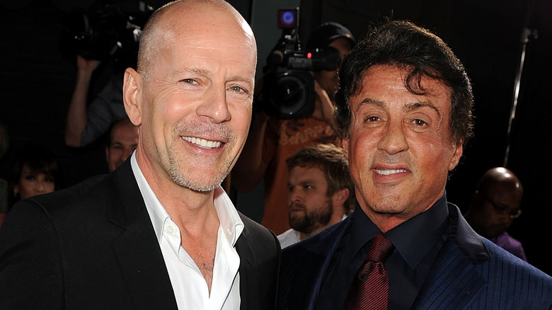 Bruce Willis and Sylvester Stallone smiling