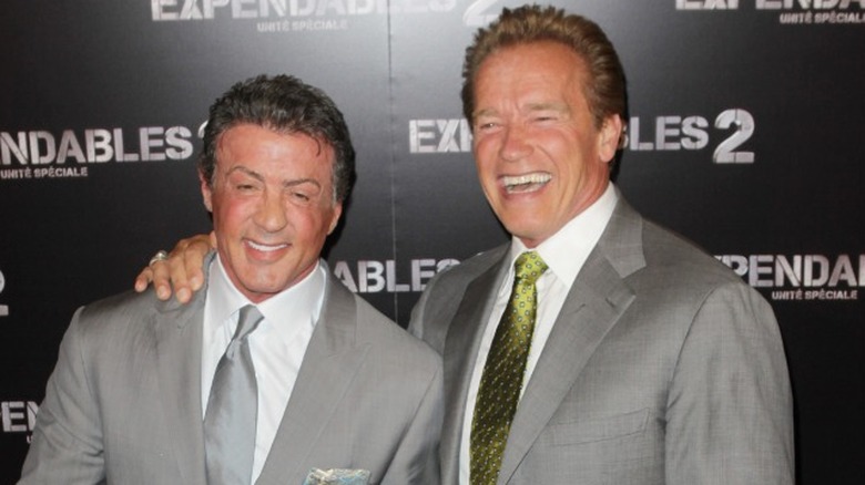 Arnold Schwarzenegger and Sylvester Stallone smiling