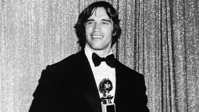 Arnold Schwarzenegger holding Golden Globe