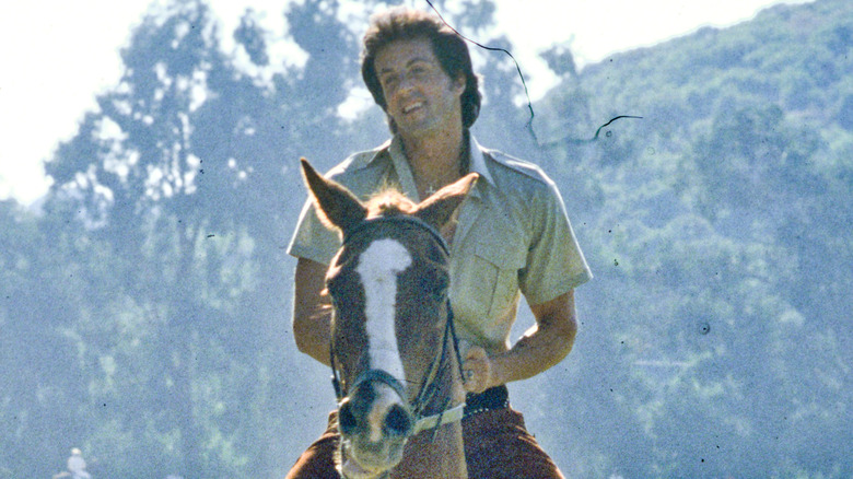 Sylvester Stallone riding a horse